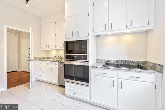a view of a kitchen with a refrigerator and window
