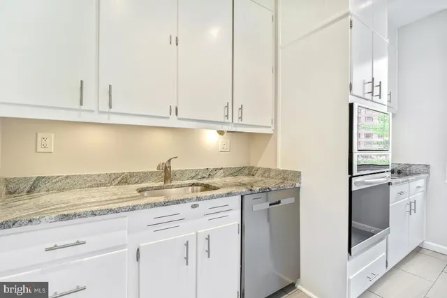 a bedroom with a bed and a potted plant