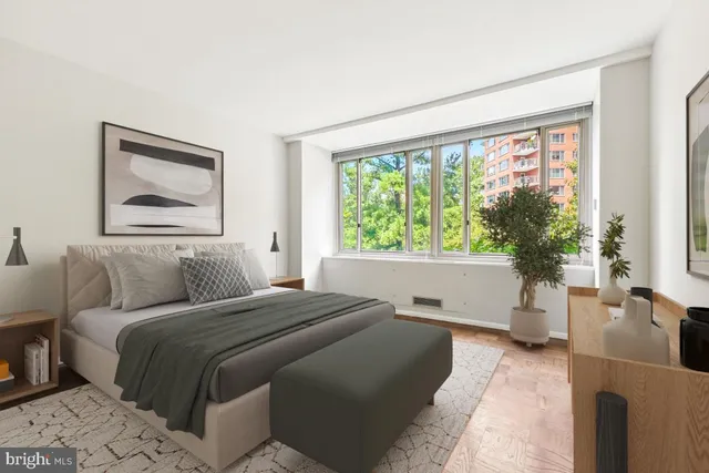 a bedroom with a bed and dresser with mirror