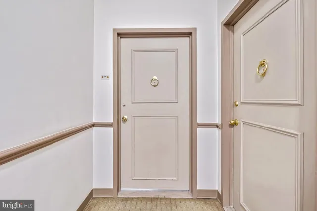 a view of a hallway with wooden door