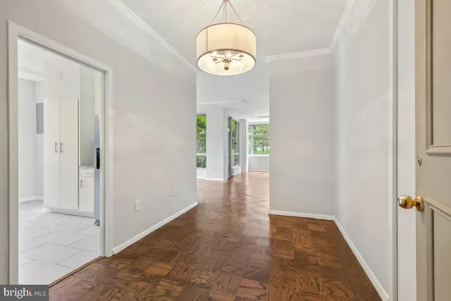 a living room with furniture and large windows