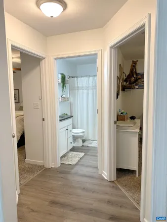 a view of a hallway and dining room and wooden floor