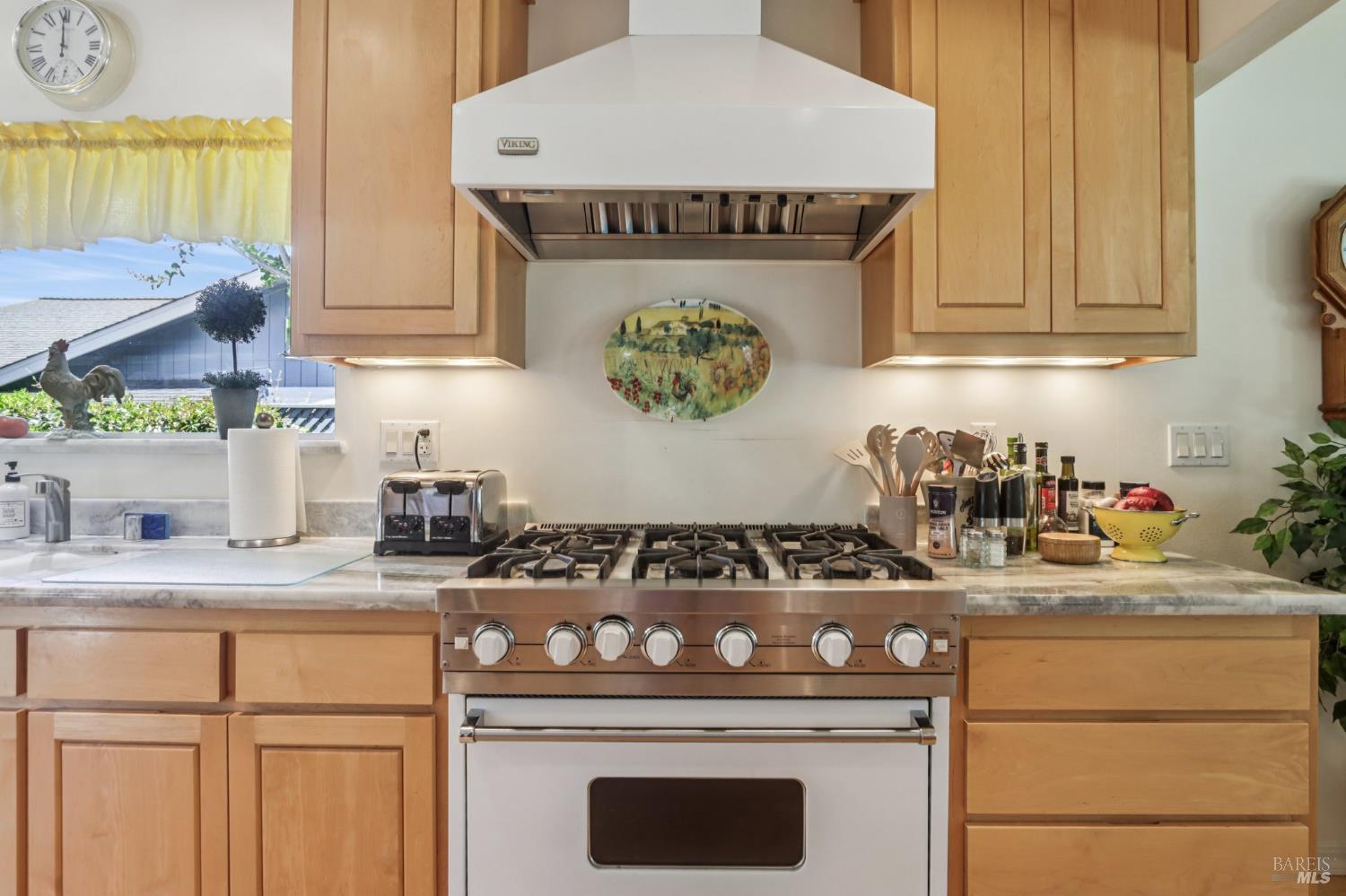 322 Mockingbird Circle Santa Rosa, CA 95409 - Photo 12 of 44 a kitchen with granite countertop a stove a sink dishwasher and cabinets with wooden floor
