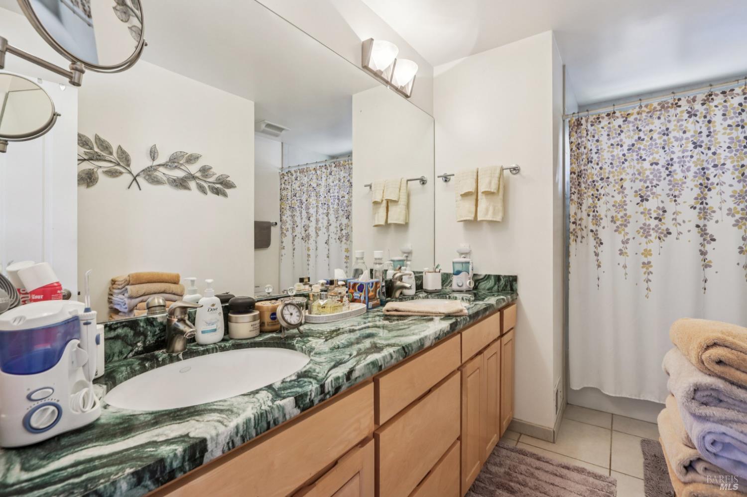 322 Mockingbird Circle Santa Rosa, CA 95409 - Photo 26 of 44 a bathroom with a granite countertop sink and a mirror