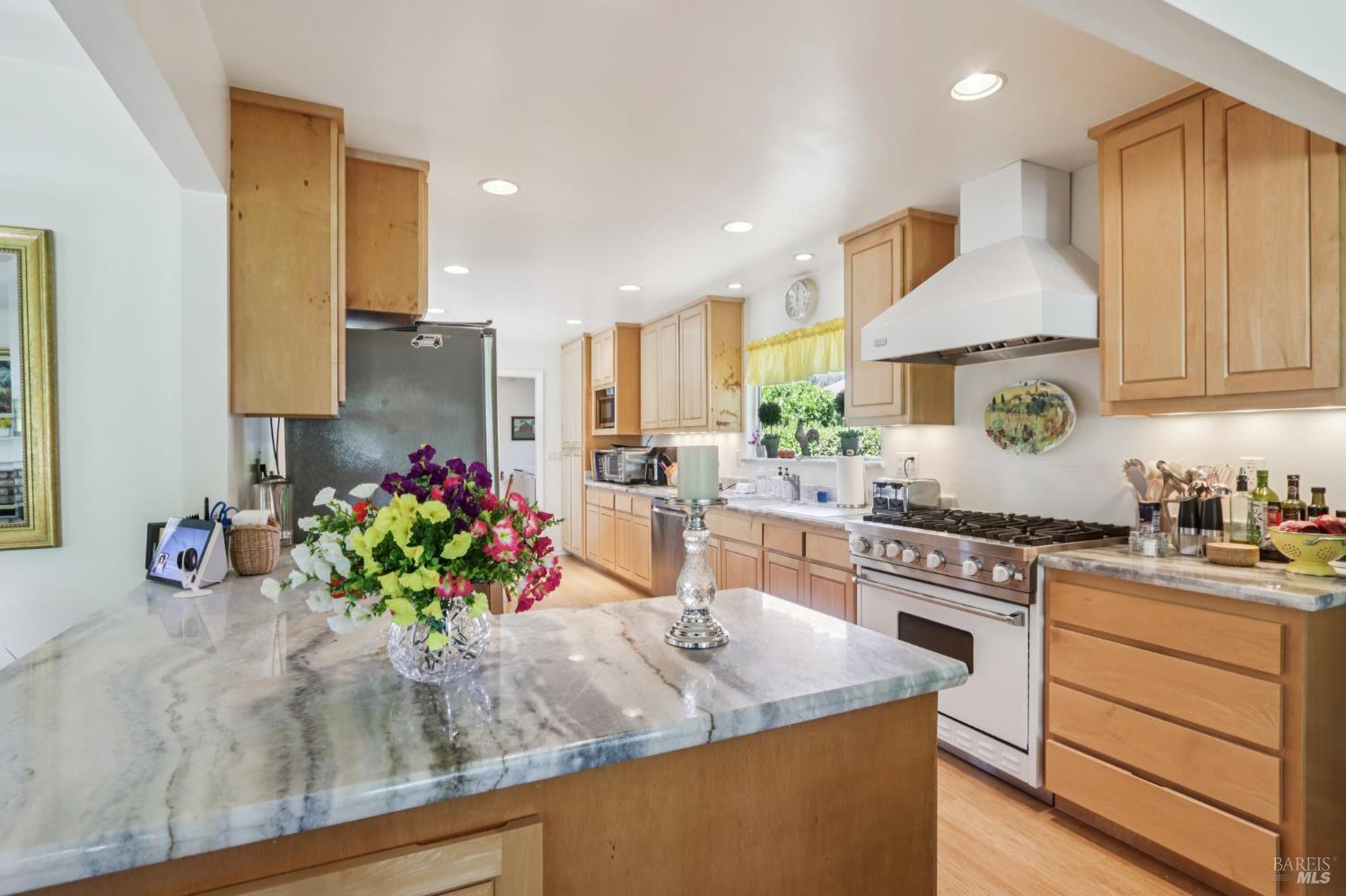 322 Mockingbird Circle Santa Rosa, CA 95409 - Photo 8 of 44 a kitchen with kitchen island granite countertop counter top space cabinets and stainless steel appliances