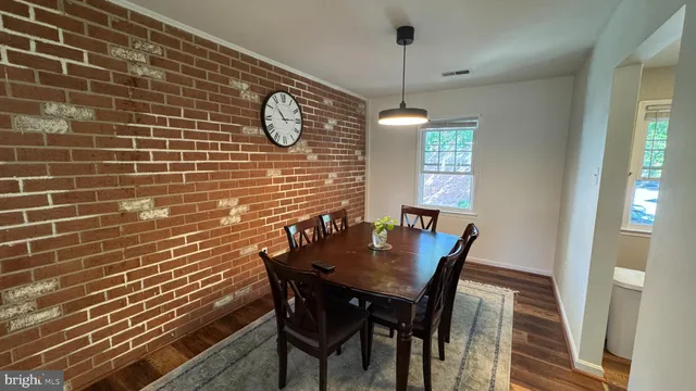 a view of a dining room with furniture and window