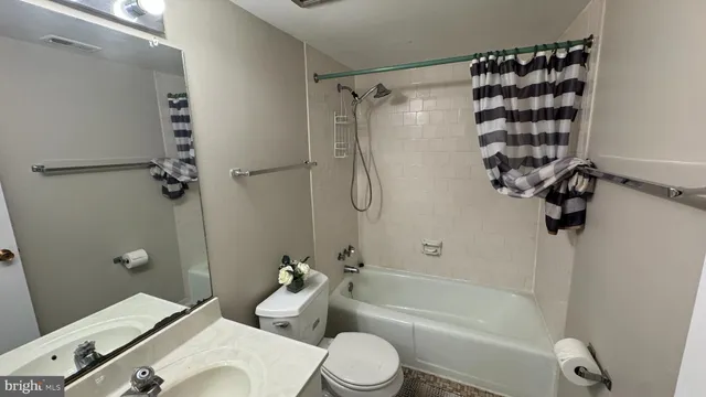 a bathroom with a shower a toilet and a bathtub
