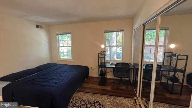 a bed sitting in a bedroom next to a window