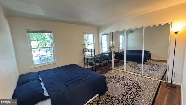 a bed sitting in a spacious bedroom next to a window
