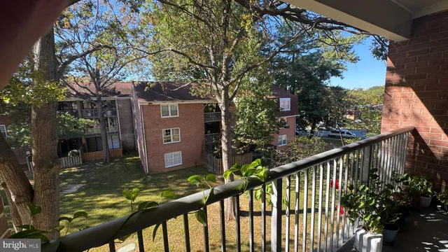 a view of a brick house with large windows and a table