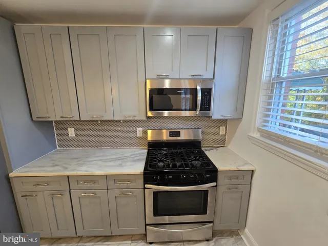 a kitchen with appliances a sink and a window