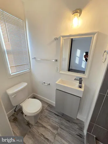 a white toilet sitting next to a bathroom sink