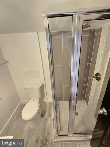 a bathroom with a shower toilet and sink