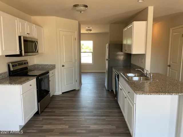 a kitchen with a sink and a stove top oven