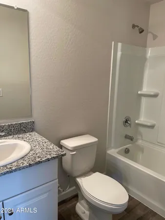 a white toilet sitting next to a bathroom sink