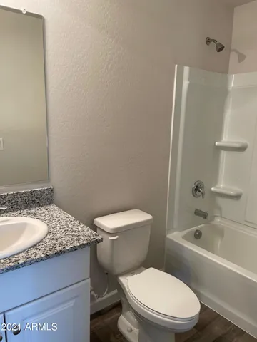 a white toilet sitting next to a bathroom sink