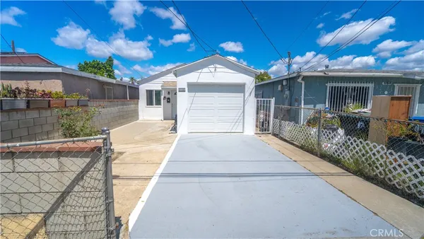 a kitchen with stainless steel appliances a refrigerator and a wooden floor