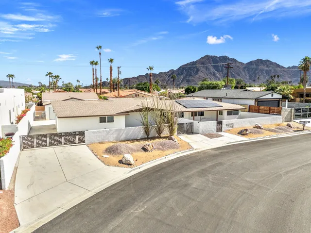 a view of a hallway with wooden floor and cabinet