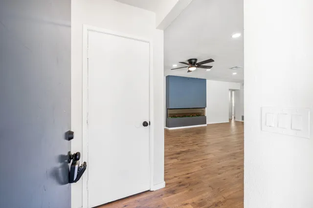 a view of a kitchen with a sink and a refrigerator