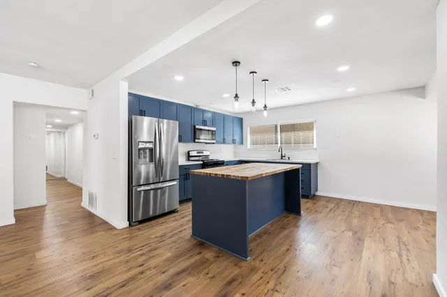 wooden floor in an empty room with a ceiling fan