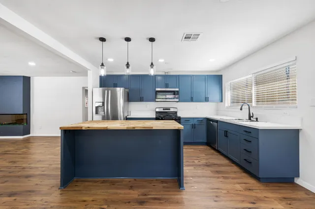 a bathroom with a granite countertop sink a toilet and a shower