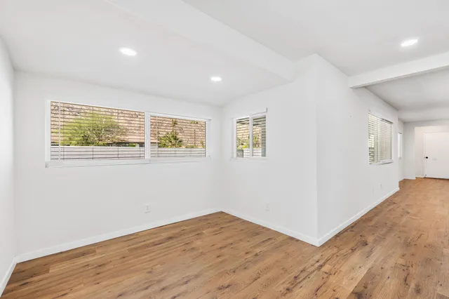 a kitchen with stainless steel appliances granite countertop a refrigerator a sink and wooden cabinets