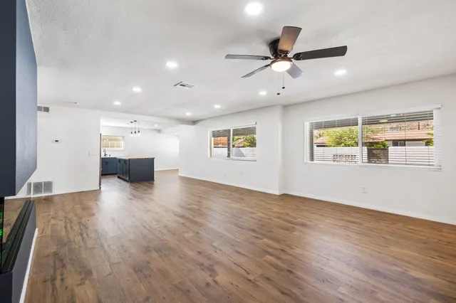 a view of empty room with wooden floor