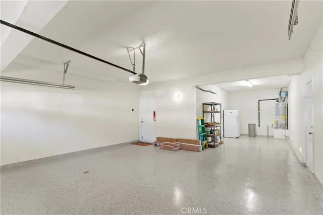 an empty room with stairs and windows