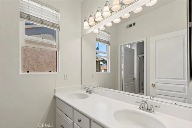 a bathroom with a sink vanity and a mirror