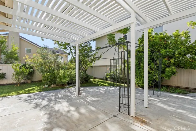 a view of a garden with plants and large trees