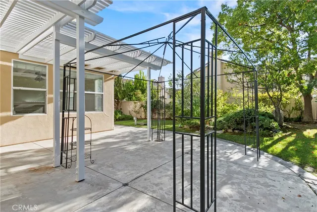 a kitchen with stainless steel appliances kitchen island granite countertop a sink stove refrigerator and cabinets