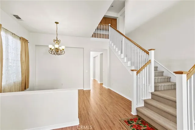 a view of entryway and hall with wooden floor