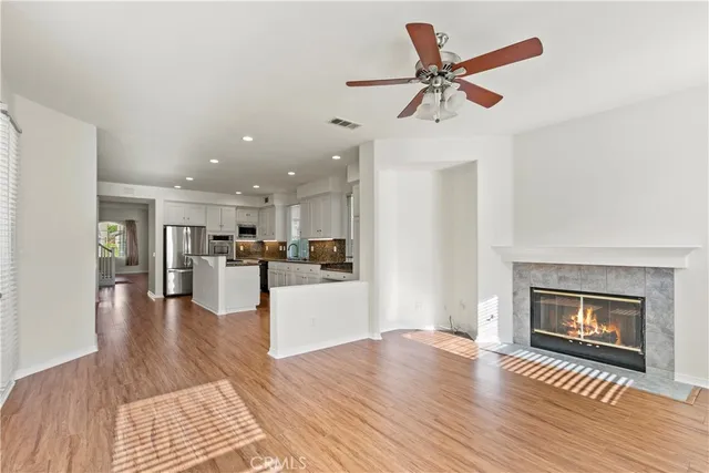 a view of a livingroom with a fireplace and wooden floor