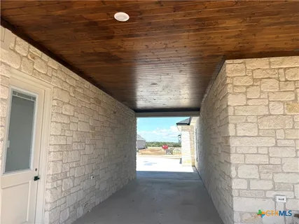 a lobby with a flat screen tv and outdoor view