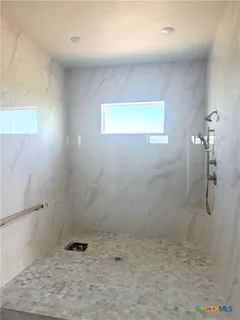a view of bathroom with a sink and mirror