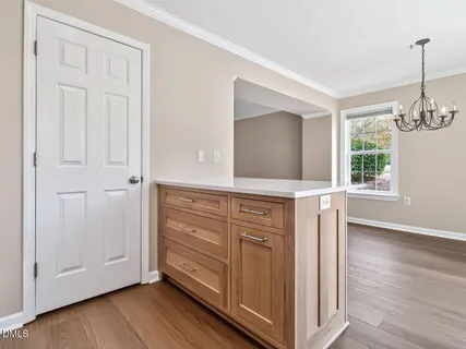 a view of a hallway with front door and wooden floor