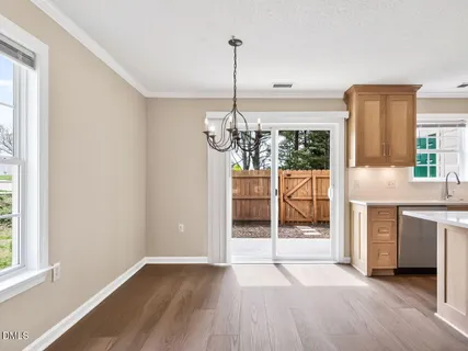a view of a kitchen with a sink and dishwasher kitchen view with wooden floor