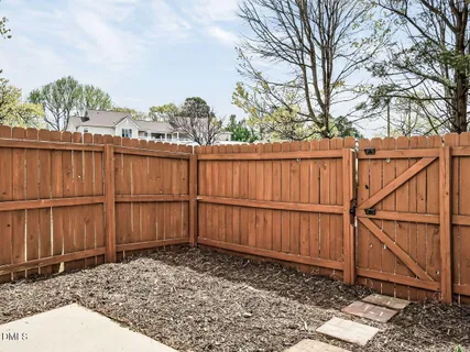 a view of a backyard with a wooden fence
