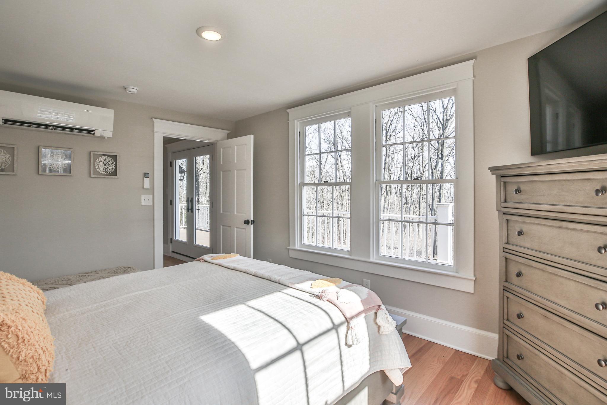 17345 Raven Rocks Road Bluemont, VA 20135 - Photo 61 of 99 a bedroom with a bed and a flat tv screen on the dresser