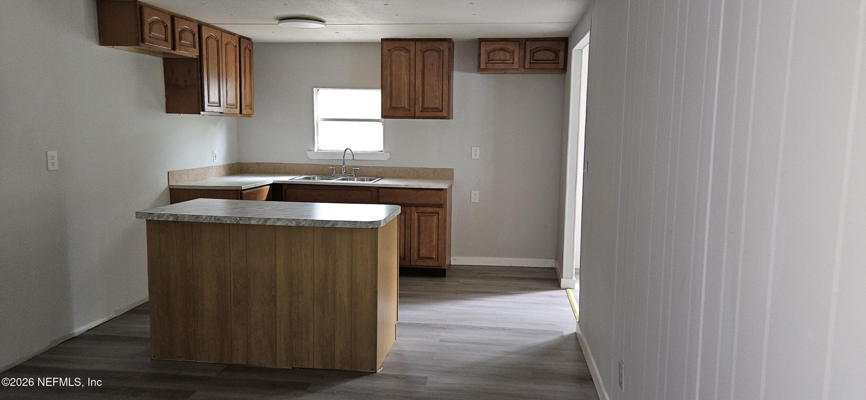 5363 Kilcrease Road Jacksonville, FL 32234 - Photo 8 of 29 a kitchen with a sink and a mirror