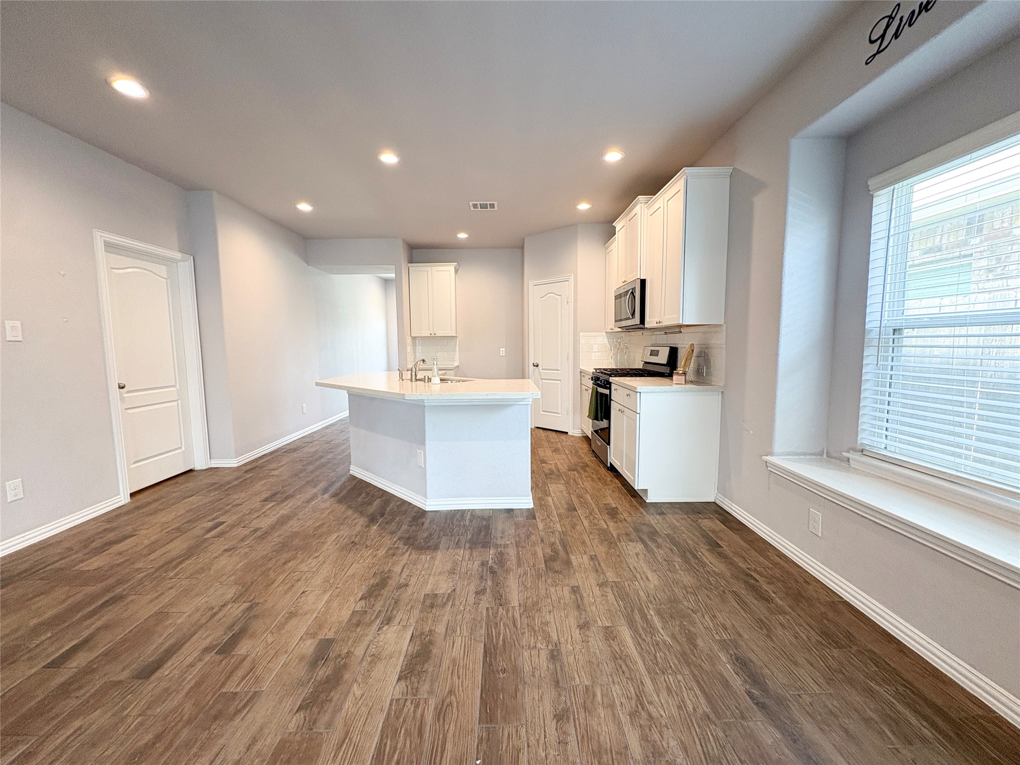 140 Kelly Street Angleton, TX 77515 - Photo 7 of 32 Open layout- kitchen opening to dining area with a big window
