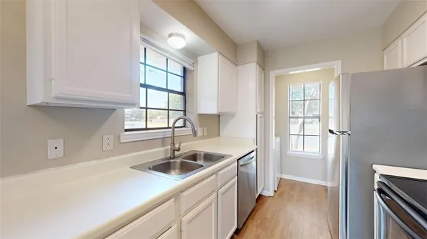 a kitchen that has a sink and cabinets