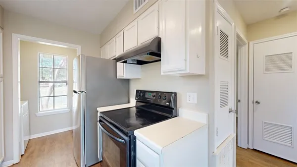 a kitchen with a stove and a microwave