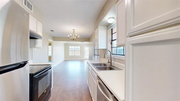a kitchen with granite countertop a sink and a stove top oven