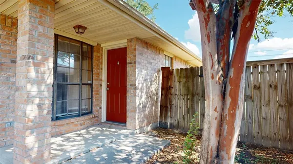 a view of a house with a door and wooden walls