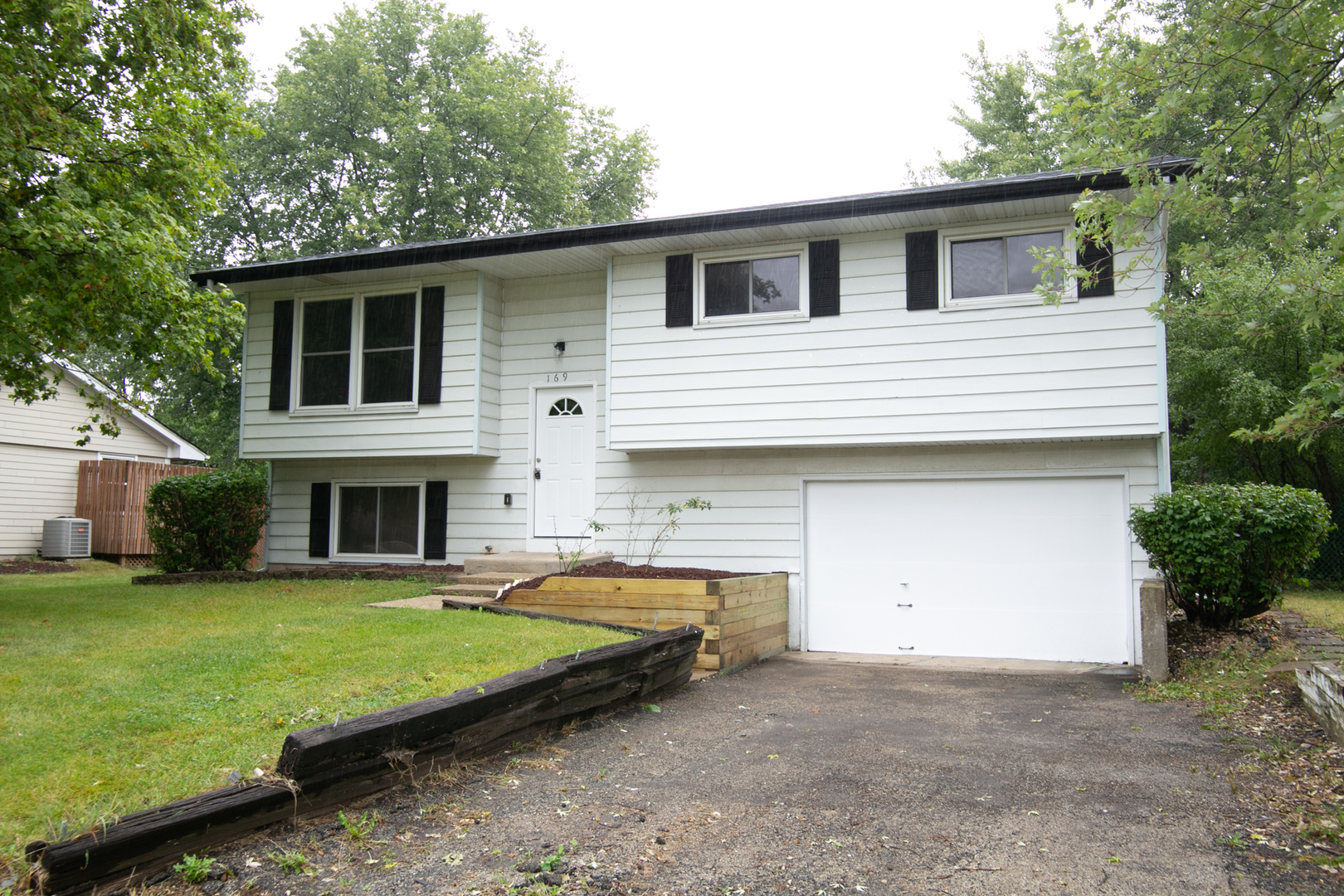N169 North Prince Crossing Road West Chicago, IL 60185 - Photo 1 of 21 a house view with a garden space