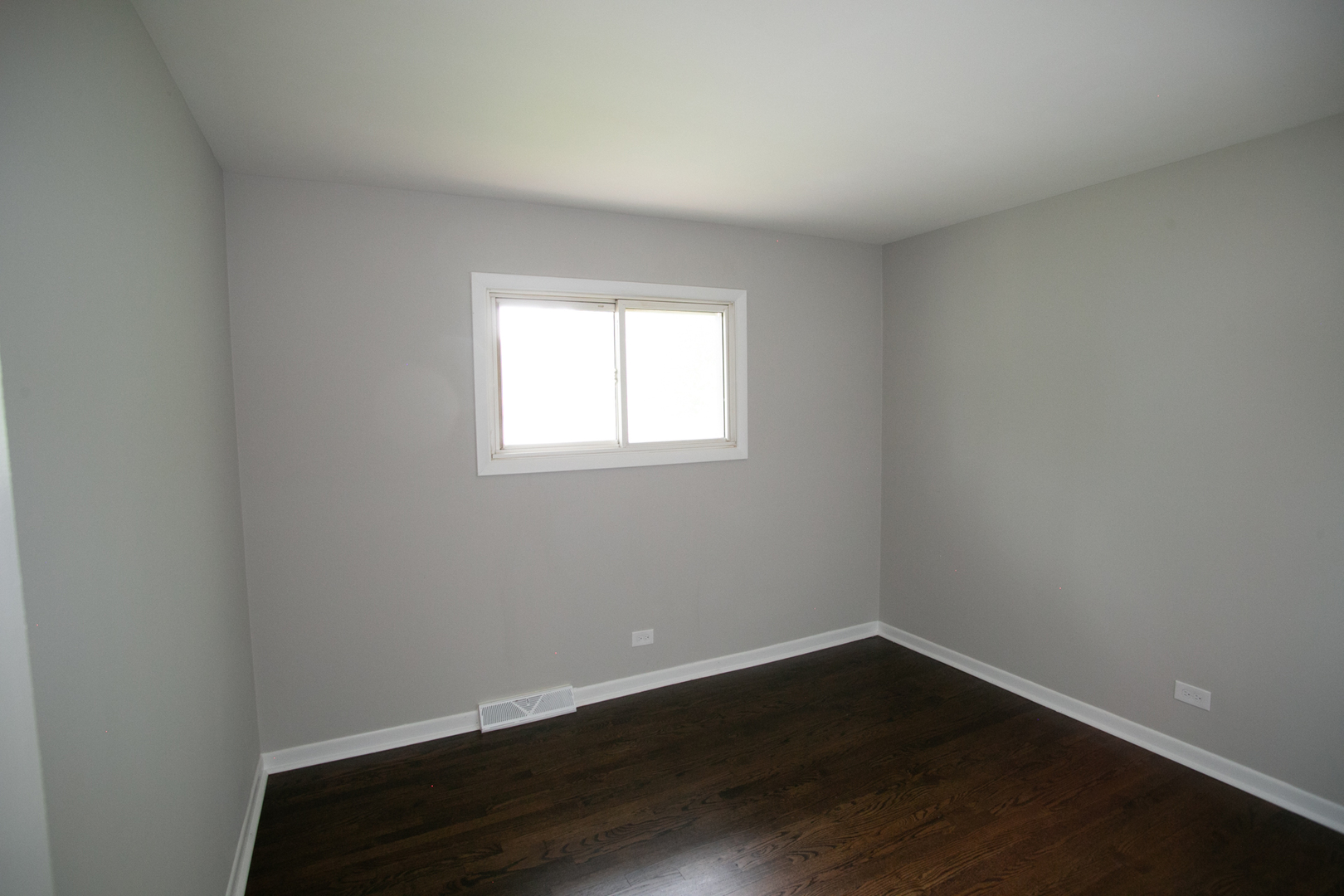 N169 North Prince Crossing Road West Chicago, IL 60185 - Photo 13 of 21 a view of an empty room with wooden floor and a window