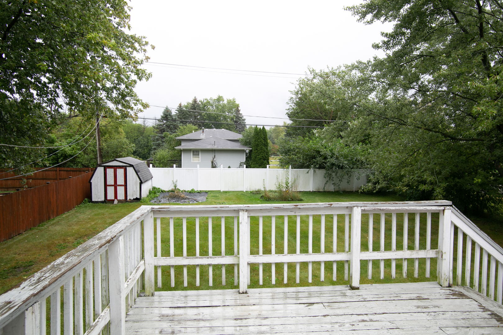 N169 North Prince Crossing Road West Chicago, IL 60185 - Photo 20 of 21 a view of a wooden deck and trees with wooden fence