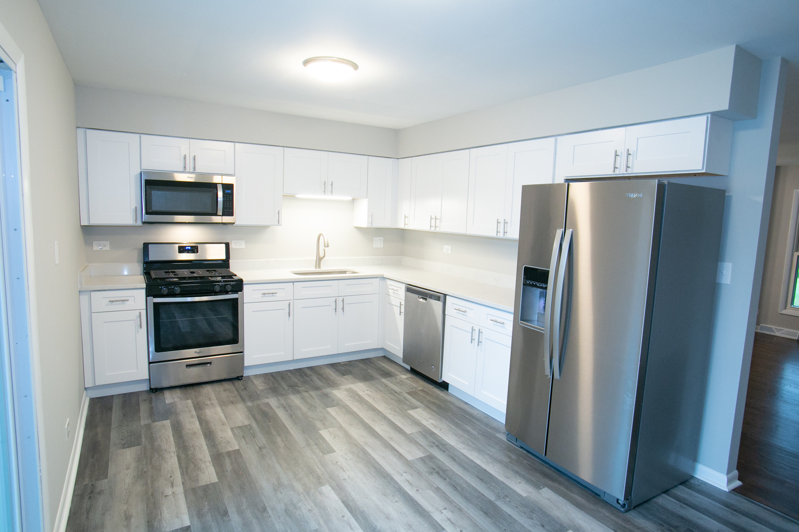 N169 North Prince Crossing Road West Chicago, IL 60185 - Photo 5 of 21 a kitchen with a refrigerator a stove top oven a sink and dishwasher