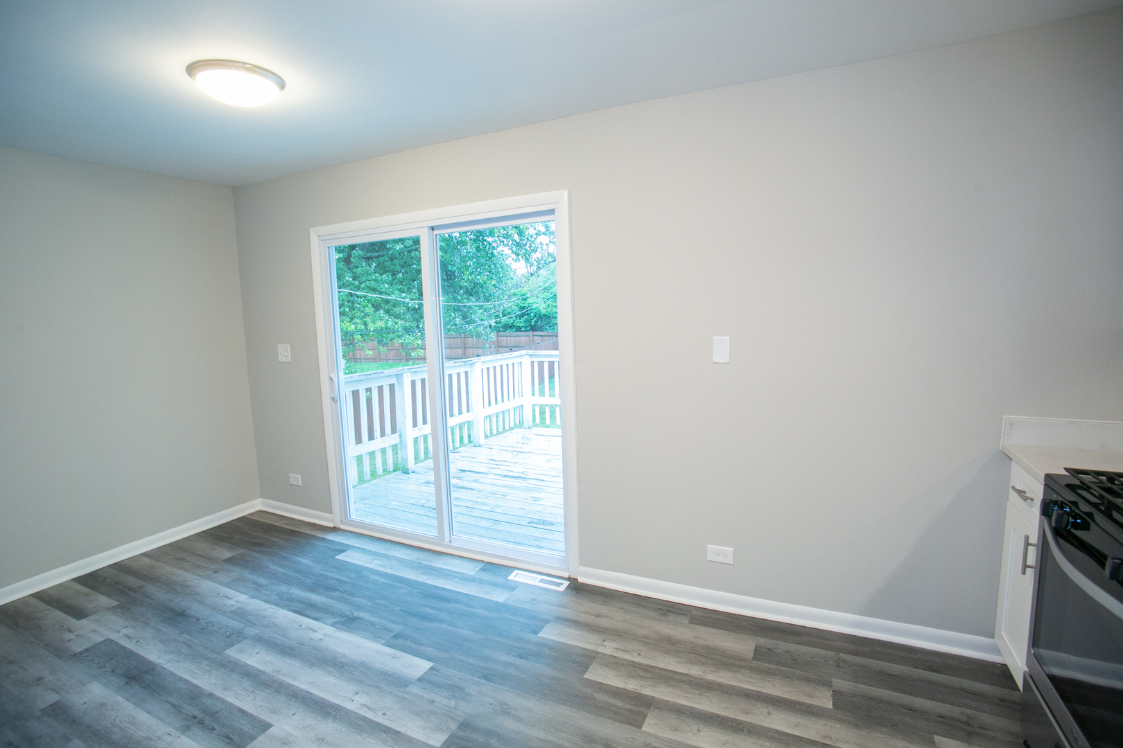 N169 North Prince Crossing Road West Chicago, IL 60185 - Photo 7 of 21 an empty room with wooden floor and sliding door